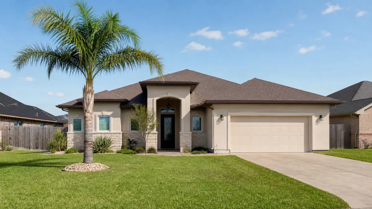 A modest single-family home with a tidy yard and a palm tree on a sunny San Benito street.